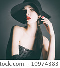 Portrait of young woman in a black hat. 10974383