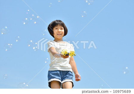 Girl playing soap bubble (blue sky) 10975689