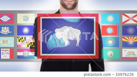 Hand pushing on a touch screen interface Hand pushing on a touch screen interface 10976226