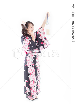 Cute girls wearing yukata laughing happily with wind chimes in hand 10980562