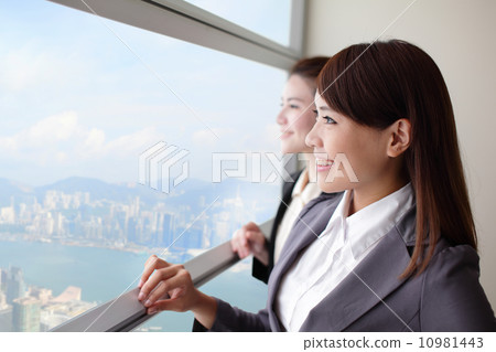 Business woman looking through window Business woman looking through window 10981443
