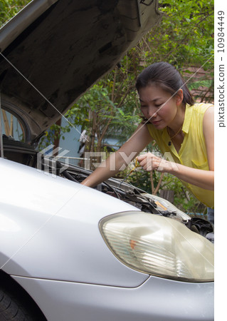 Asian women repair broken car Asian women repair broken car 10984449