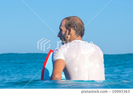 Surfing a wave. 10993363