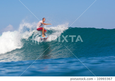 Surfing a wave. 10993367