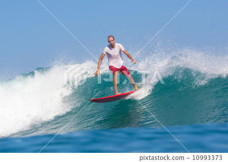 Surfing a wave. 10993373