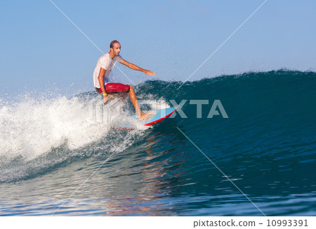 Surfing a wave. 10993391