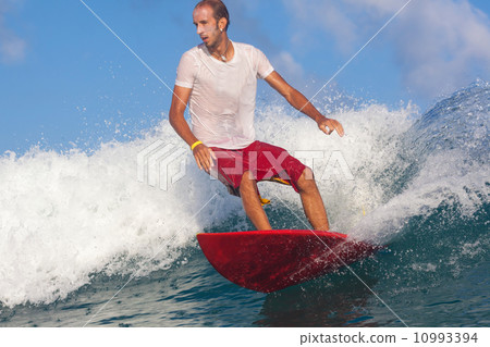 Surfing a wave. 10993394