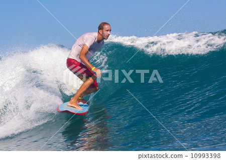 Surfing a wave. 10993398