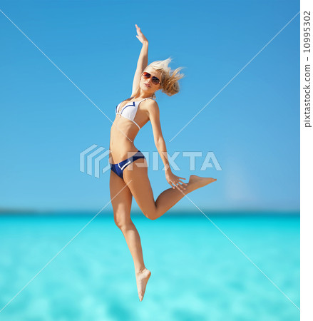 happy woman jumping on the beach 10995302
