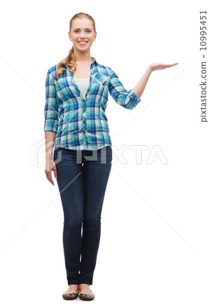 smiling young woman holding something on hand smiling young woman holding something on hand 10995451