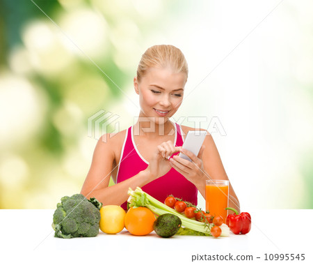 woman with vegetables pointing at smartphone woman with vegetables pointing at smartphone 10995545