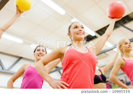 group of people working out with stability balls 10995559