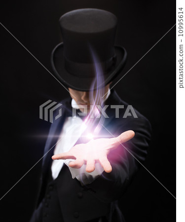 magician holding something on palm of his hand magician holding something on palm of his hand 10995614