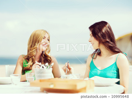 girls in cafe on the beach 10995648
