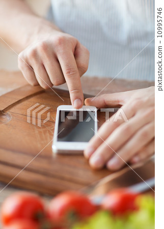 closeup of man pointing finger to smartphone 10995746