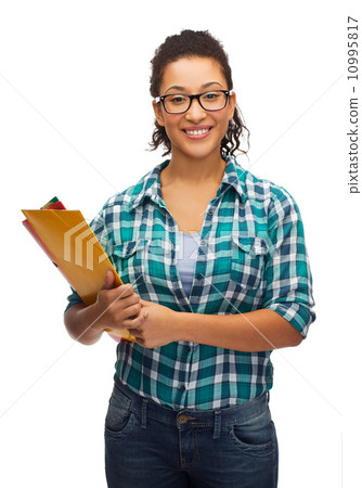 female black student in eyeglasses with folders 10995817