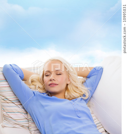 smiling young woman lying on sofa smiling young woman lying on sofa 10995831