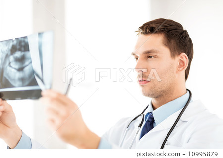 male doctor or dentist looking at x-ray male doctor or dentist looking at x-ray 10995879