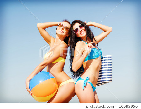 girls with ball on the beach 10995950