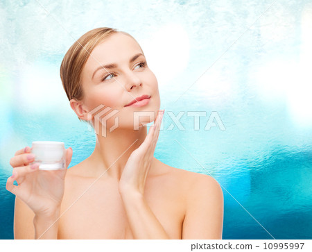 woman applying cream on her skin woman applying cream on her skin 10995997
