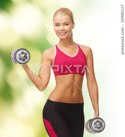smiling woman with heavy steel dumbbells smiling woman with heavy steel dumbbells 10996127