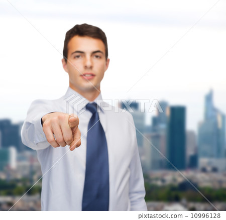 friendly young buisnessman pointing finger friendly young buisnessman pointing finger 10996128