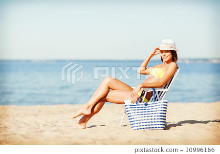 girl sunbathing on the beach chair 10996166