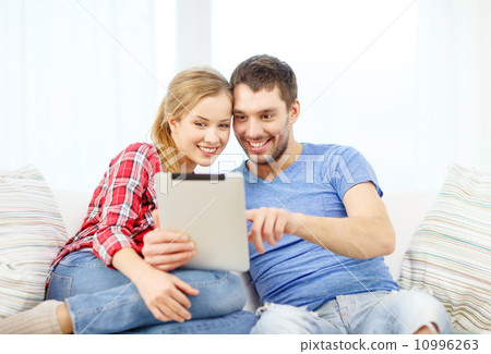 smiling couple with tablet pc computer at home smiling couple with tablet pc computer at home 10996263