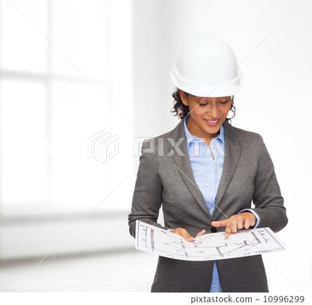 businesswoman in white helmet with blueprint businesswoman in white helmet with blueprint 10996299