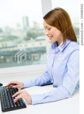 smiling businesswoman or student with computer smiling businesswoman or student with computer 10996382