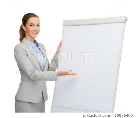 smiling businesswoman standing next to flipboard smiling businesswoman standing next to flipboard 10996400