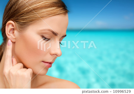 calm woman touching her ear calm woman touching her ear 10996529