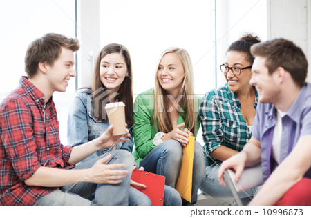 students communicating and laughing at school 10996873