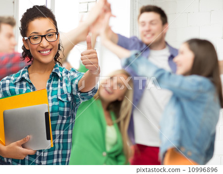 student in eyeglasses with folders and tablet pc 10996896