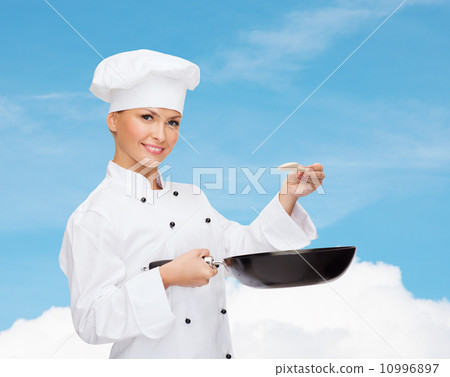 smiling female chef with pan and spoon 10996897