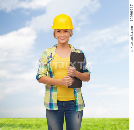 smiling woman in helmet with clipboard 10996937