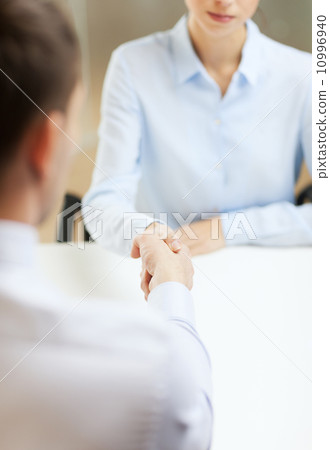 businesswoman and businessman shaking hands businesswoman and businessman shaking hands 10996940