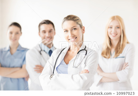 female doctor in front of medical group female doctor in front of medical group 10997023