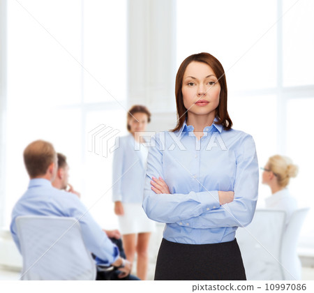 smiling businesswoman with crossed arms at office smiling businesswoman with crossed arms at office 10997086
