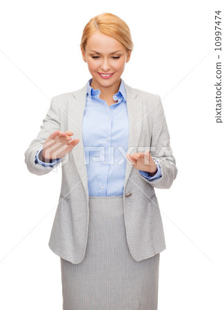 smiling businesswoman pointing to something smiling businesswoman pointing to something 10997474