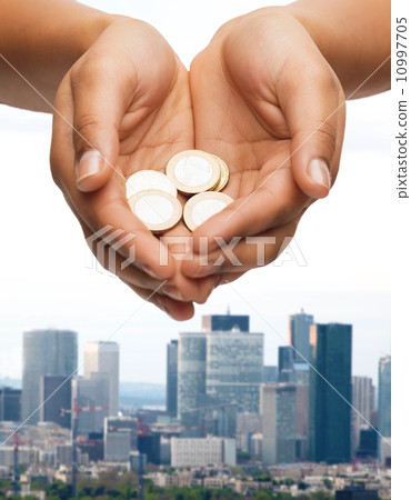 womans cupped hands showing euro coins womans cupped hands showing euro coins 10997705