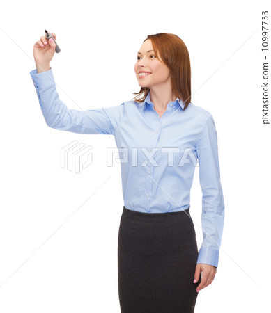 businesswoman writing something in air with marker businesswoman writing something in air with marker 10997733