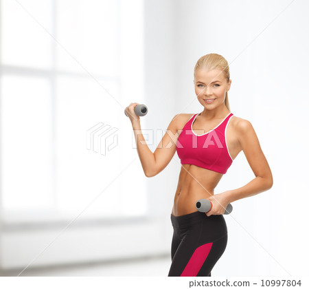 young sporty woman with light dumbbells 10997804
