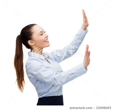 smiling businesswoman pointing to something 10998085