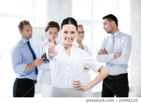 businesswoman in office showing thumbs up businesswoman in office showing thumbs up 10998120