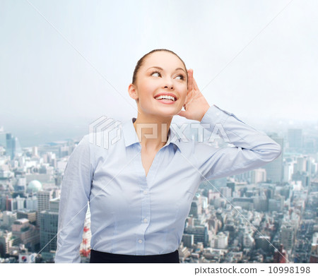 smiling businesswoman listening gossig 10998198