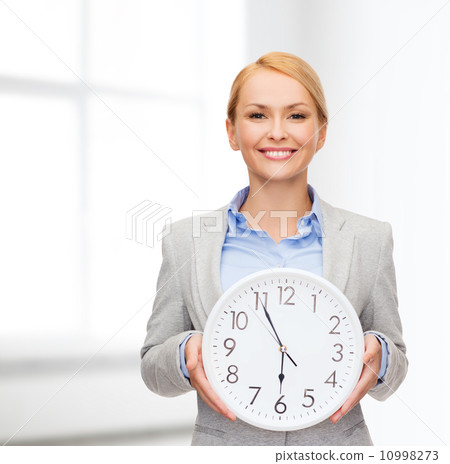 smiling businesswoman with wall clock 10998273