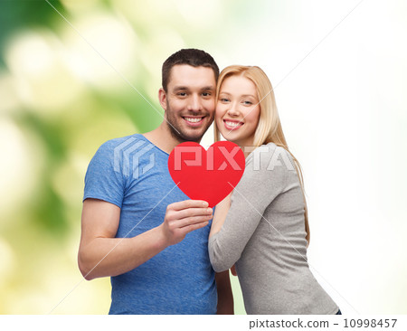smiling couple holding big red heart smiling couple holding big red heart 10998457