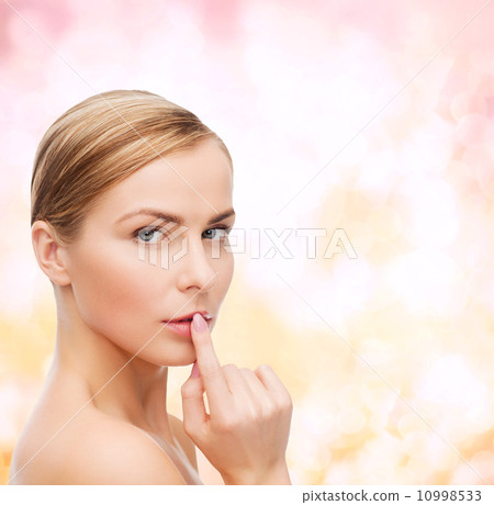 young woman doing hush gesrute 10998533