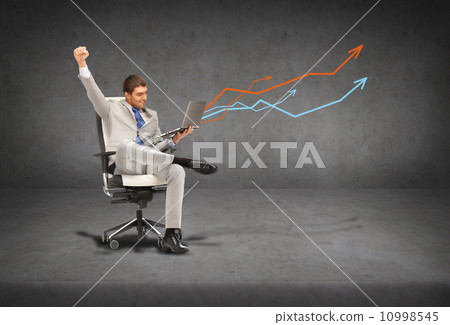 young businessman sitting in chair with laptop young businessman sitting in chair with laptop 10998545